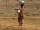 A woman carrying water in rural India, where Mary was born